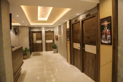 a hallway with wooden doors in a building at Mezkar Residency in Alwaye