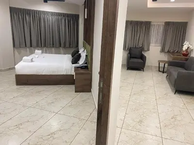 a bedroom with a bed and a living room at Mezkar Residency in Alwaye