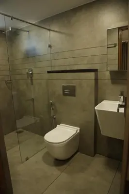 a bathroom with a toilet and a shower and a sink at Mezkar Residency in Alwaye