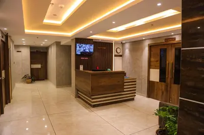 a hotel lobby with a reception desk and a tv at Mezkar Residency in Alwaye