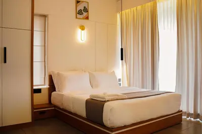 a bedroom with a large bed with a window at Leaves Resort Vythiri Wayanad in Vythiri