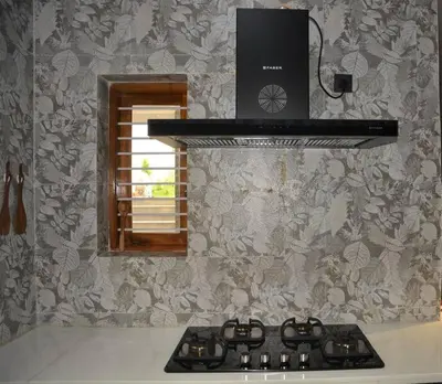 a stove top in a kitchen with a window at Earth - Luxurious 5 BHK AC Villa at Mysore in Mysore