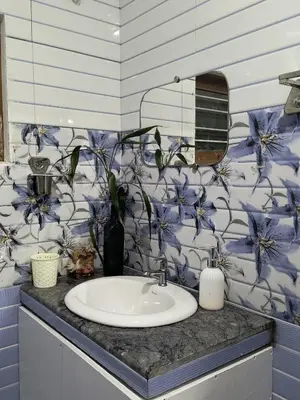 a bathroom sink with a blue and white floral wallpaper at Nama-Stay - An escape villa in Ooty