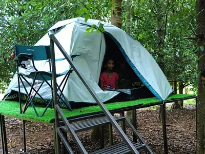 a woman in a tent with a girl in it at Dragster Tents in Kizhake Chālakudi