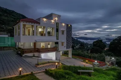 a white house with lights on top of it at AVJ Nest, Kodaikanal in Kodaikānāl