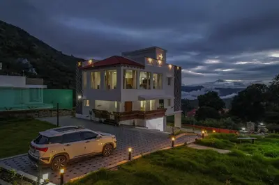 a car parked in front of a house at night at AVJ Nest, Kodaikanal in Kodaikānāl