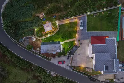 an aerial view of a house with a road at AVJ Nest, Kodaikanal in Kodaikānāl