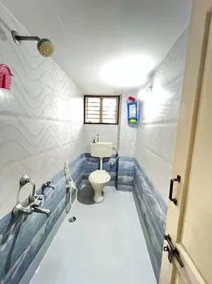 a bathroom with a toilet and a sink at Chamundi_Temple-Hill View. in Mysore