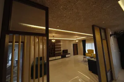 a living room with a couch and a living room with at Ncomforts Luxurious Apartments in Perintalmanna