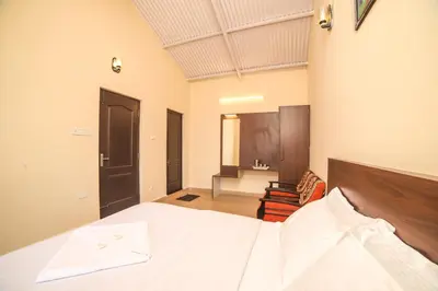 a bedroom with a large bed with a white bedspread at The Springs by Indo Stays in Yedapalli