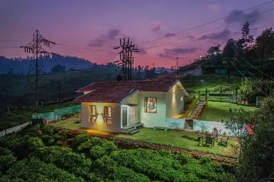 a small house on a hill at night at The Springs by Indo Stays in Yedapalli