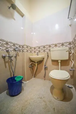 a bathroom with a toilet and a sink at The Springs by Indo Stays in Yedapalli