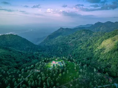 an aerial view of a mountain valley with a house at ama Stays & Trails Anjanagiri , Kotagiri in Kotagiri