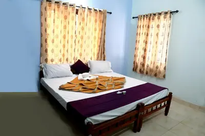 a bed with a tray of food on it at DREAMS VILLA Near Rajagiri Hospital in Alwaye