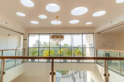 a room with a balcony with a chandelier at Royal Holidays & Stays in Pattāmbi