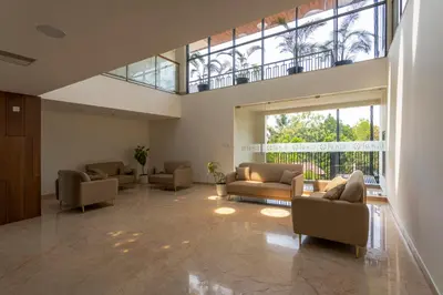 a large living room with couches and a large window at Royal Holidays & Stays in Pattāmbi