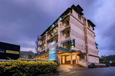 a pink building with a sign in front of it at Le Celestium in Munnar