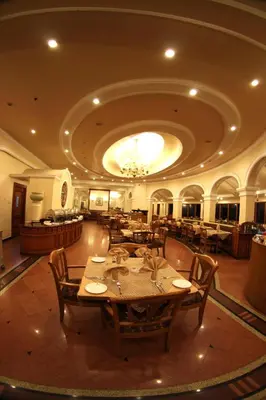 a large dining room with tables and a chandelier at KTDC Tea county in Munnar