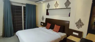 a bedroom with a large white bed and a window at Happy Vibes studio flats - service apartment in Mysore
