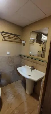 a bathroom with a sink and a mirror at Happy Vibes studio flats - service apartment in Mysore