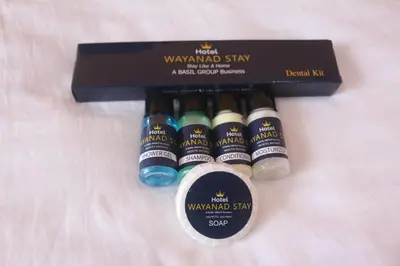 a box of seven bottles of wine on a bed at Hotel Wayanad Stay in Kalpetta