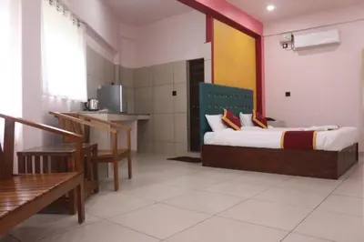 a hotel room with a bed and a kitchen at Hotel Wayanad Stay in Kalpetta