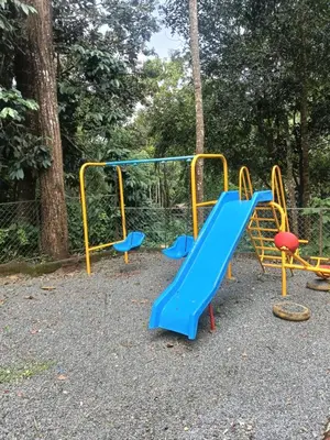 a playground with a blue and yellow slide at Regalia Wayanad in Kalpetta