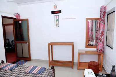 a room with two beds and a mirror at Ocean Green Kerala in Kannur
