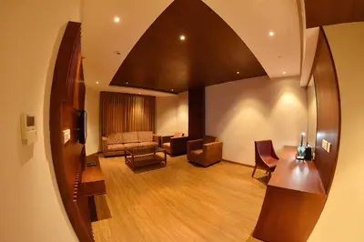 a living room with a couch and a table at THE PEARL VIEW HOTEL in Mulappilangād