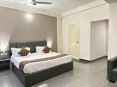 a bedroom with a large bed in a room at Nexstay Kassaba Inn in Kozhikode