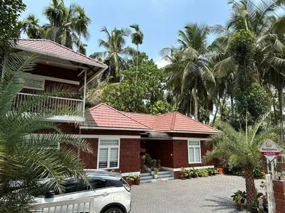 a house with a car parked in front of it at Redstone Villa in Tāzhekkod