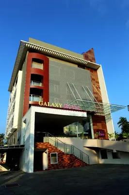 a building with a carley morgan sign on it at Paravoor Galaxy Hotel in Cherai Beach