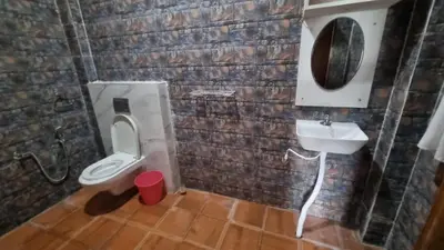 a bathroom with a toilet and a sink at Sandiago Villa 2 Bhk House in Ooty
