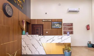 a reception area of a hospital with a clock on the wall at Treebo The Rove with Swimming Pool in Madikeri