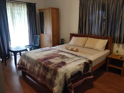 a bedroom with a large bed and a window at Cloud & Mist Inn-Stay with Mountain Views in Kotagiri, Near Ooty in Kotagiri