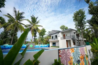 a villa with a swimming pool and a house at Gandhada Goodu Retreat in Kanakapura