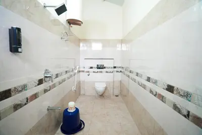 a bathroom with a toilet and a sink at Gandhada Goodu Retreat in Kanakapura