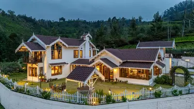 a large house with a fence in front of it at The Winterfel in Yedapalli