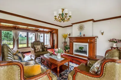 a living room with leather furniture and a fireplace at The Winterfel in Yedapalli