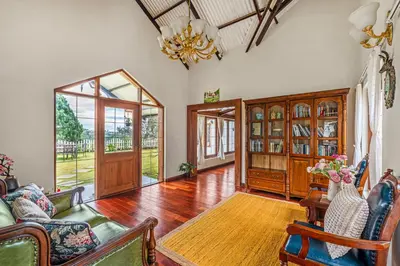 a living room filled with furniture and a chandelier at The Winterfel in Yedapalli