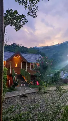 a house with a view of a mountain at Don's River Valley Jungle Resort in Marayoor
