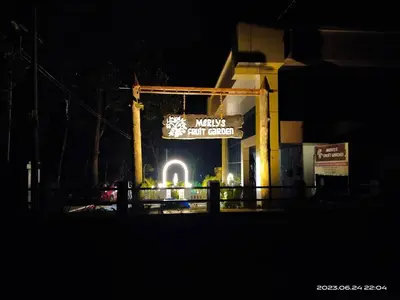 a sign for a fast food restaurant at night at Family Cottage at Merlys Fruit Garden, Thattekkad in Kotamangalam