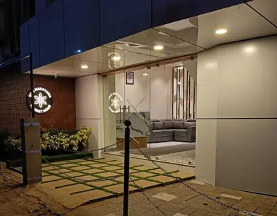 a living room with a couch in a building at SREENARAYANA TOURIST HOME in Guruvāyūr