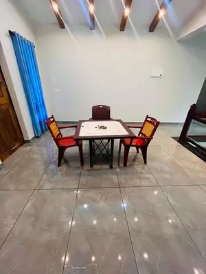a table and two chairs in a room at Chaithanya Residency Near to NIT Kozhikode in Kunnamangalam