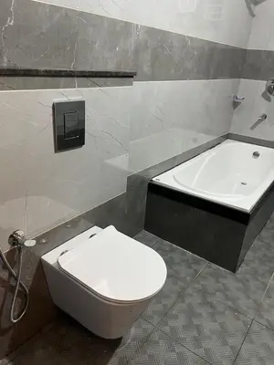 a bathroom with a toilet and a bath tub at Chaithanya Residency Near to NIT Kozhikode in Kunnamangalam