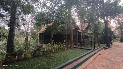 a tree house with a fence and some plants at Tree House Wayanad in Muthanga