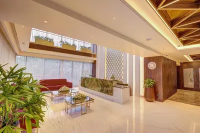 a lobby with a living room with a couch and tables at Regenta Central Javaji Mysore in Mysore