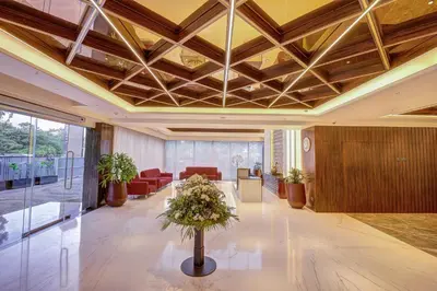 a lobby with a table with flowers on it at Regenta Central Javaji Mysore in Mysore