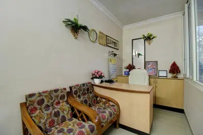 a waiting room with a chair and a desk at PRANOV RESIDENCY-Luxury in Coimbatore