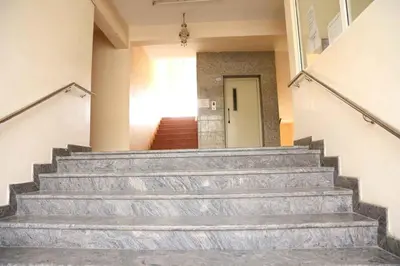 a set of stairs in a building with a door at PRANOV RESIDENCY-Luxury in Coimbatore